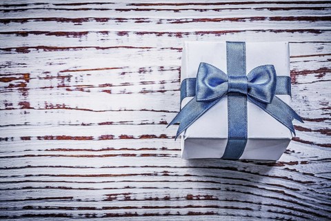 Present box on vintage wooden board holidays concept