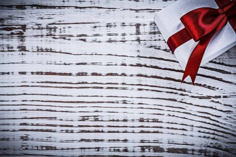 Present box on vintage wooden board copyspace holidays concept