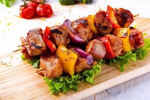 Tasty and colorful meat skewers with peppers and onions