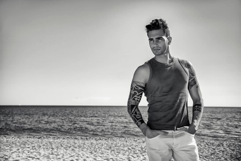 Three Quarter Shot of a Handsome Athletic Young Man in Trendy Attire, on a Beach in a Sunny Summer