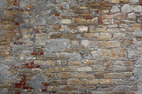 Rustic wall made of clay bricks brown and red