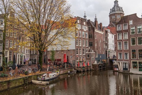 Historic buildings and boats on an Amsterdam canal in autumn, Amsterdam, Netherlands