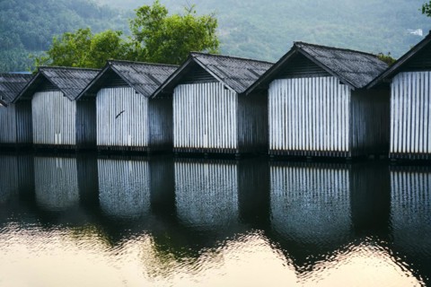 Row of houses on the river with reflections in the water