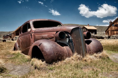 Rusty car wreck in the abandoned gold mining town of Bodie, USA