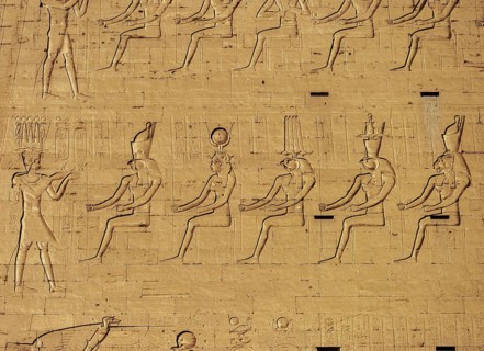 Hieroglyphic carvings on the exterior walls of an ancient egyptian temple