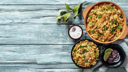 Pakistani food - biryani rice with chicken and raita yoghurt dip. Delicious hyberabadi chicken