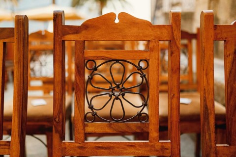 Forged pattern on the back of a wooden chair. Close-up.