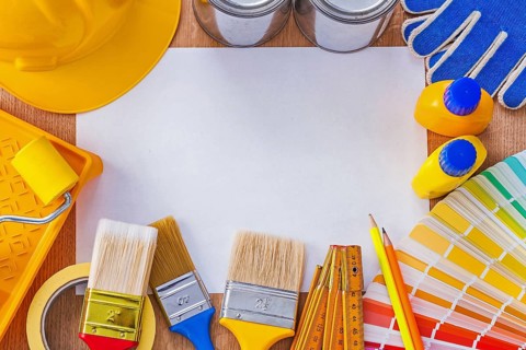 Collection of repair and paint tools on clean sheet of paper construction concept