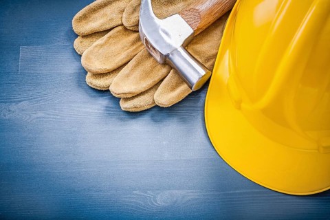 Composition of building helmet claw hammer protective gloves construction concept