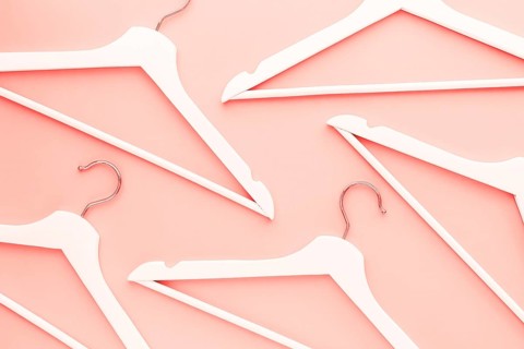 Creative top view flat lay wooden hangers toned living coral color of the year 2019 background copy