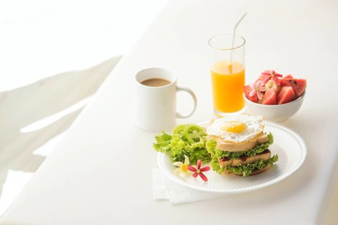 Egg and salad sandwich with fruit salad juice and coffee breakfast set
