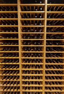 Bottles with wine stacked on wooden racks