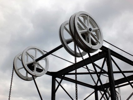 Wheels and pulleys on the historic canal chain bridge in Huddersfield West Yorkshire against grey