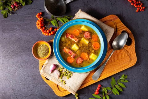 Polish pea soup (grochowka) with smoked bacon and sausage