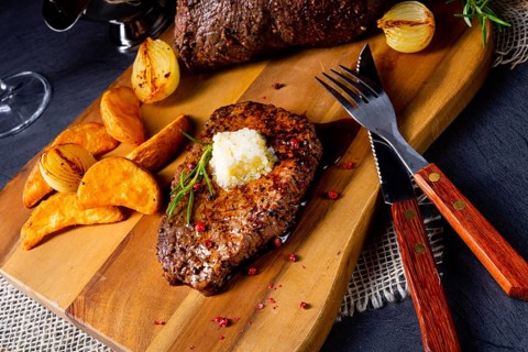 Butter beef steak with herbs and potato wedges