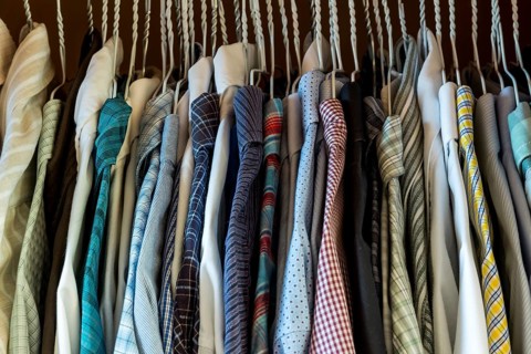 Bedroom wardrobe with men's shirts on hangers, selection and organisation Austria