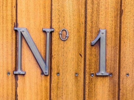 The designation number one on a wagon of a train. Symbolic photo for First and Best. Austria