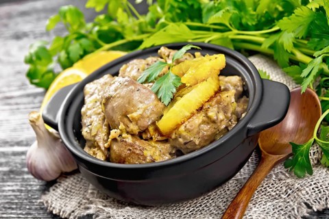 Chicken liver stewed with oranges, sour cream, soy sauce and Provence herbs in a small pan on