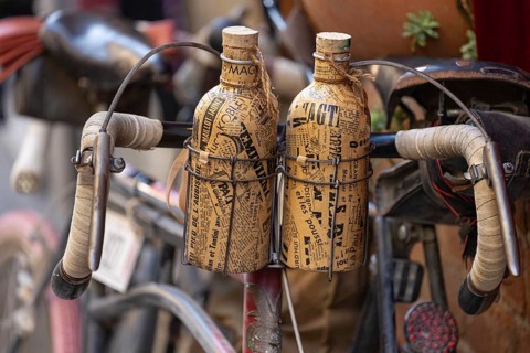 Two retro bottles attached to an old bicycle handlebar, at the legendary L'Eroica cycling race,
