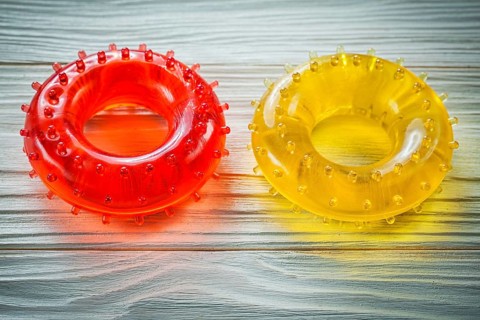Rubber round hand expanders on wooden board sports training concept