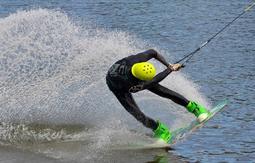 Russia, Volgodonsk - June 18, 2015: Water snowboard. The athlete with snowboard hold on to the rope
