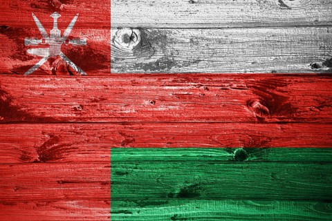 Oman flag on wooden planks background wood flag