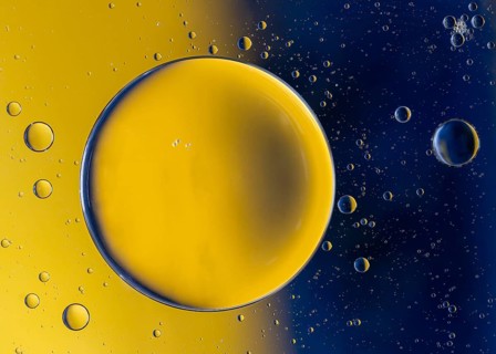 Abstract macro with oil drops in water, looking like planets in space