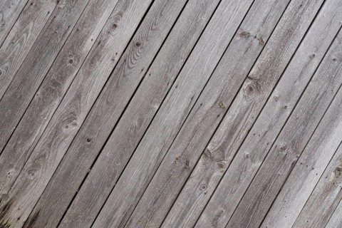 Crooked weathered old wooden wall - text space, close-up