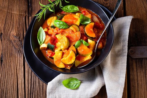 Vegetarian courgette ratatouille with tomato sauce and herbs