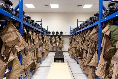 Dressing room of a fighter aircraft (jet fighter) pilot with uniforms and helmets with breathing