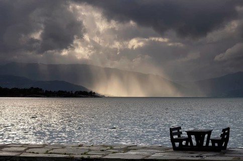 Empty picnic table in in the Norwegian village Herand in front of a dramatic sky over the
