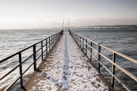 A snow-covered jetty stretches far out onto the calm lake, Hörnle, Constance, Lake Constance,