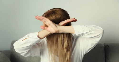 Close-up upset young woman shows stop, no or enough sign with palm of hand, refusal gesture,