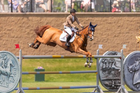 Elena A. Haas, from the United States and riding Claude, compete in the 1.60m Grand Prix during The