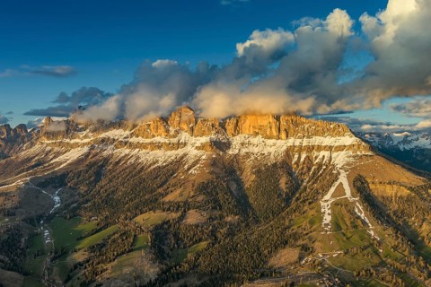 Aerial view of amazing rocky mountains in snow at sunset, Dolomites, Italy