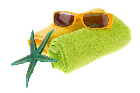 Green towel, starfish and sunglasses for the beach