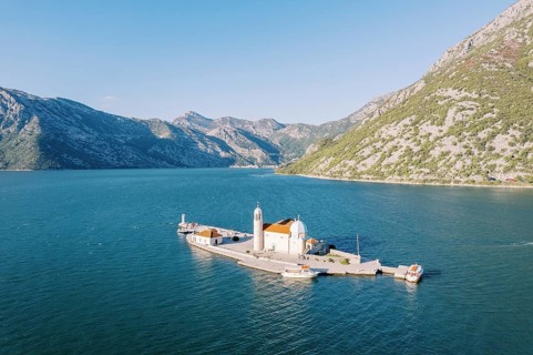 Church of Our Lady of the Rocks on the island of Gospa od Skrpjela. Bay of Kotor, Montenegro. Drone