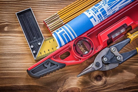 Construction level tin snips engineering drawing wooden meter square ruler on wood board