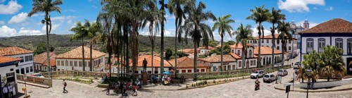 Panorama of traditional houses and palm tree lined street in historic center of Diamantina on a