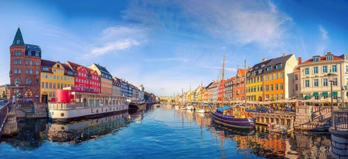 Panorama of the Nyhavn canal with boats, ships and many small colorful houses. Copenhagen, Denmark