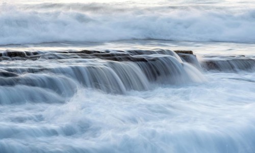 Rocky seashore with wavy ocean and waves crashing on the rocks at Akrotiri coast area in Limassol,