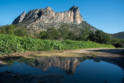 Famous Pentadaktylos rocky mountain peaks reflected on water in Kerynia town in Cyprus late in the