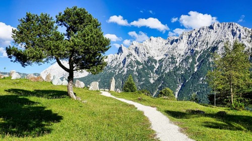 Rock garden on the hiking trail from Lautersee to Mittenwald with Karwendel mountains and huts