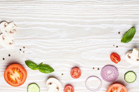 Food cooking background: arranged fresh ingredients, basil, cherry tomatoes, mushrooms, cut