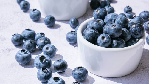 Fresh blueberries background with copy space. Blueberry antioxidant organic superfood in bowls