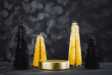 Podium pedestal product mockup display with miniature Christmas trees in black and gold, 3d