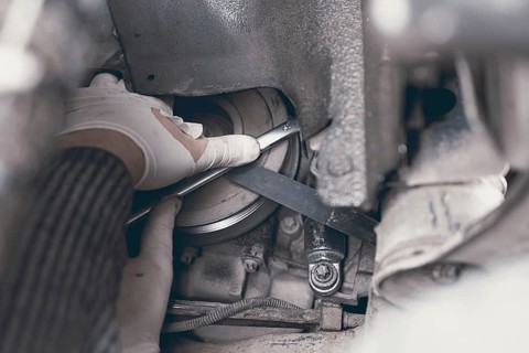 Hands of car mechanic in auto repair service