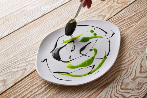 Modern cuisine chef preparation with creamy spots Molecular gastonomy