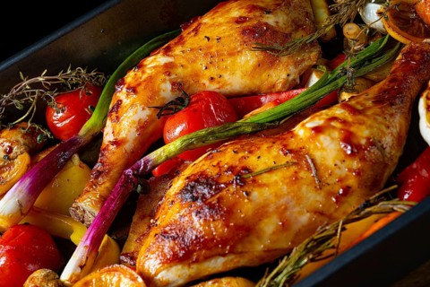 Roasted chicken legs with various vegetables