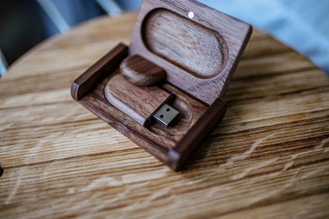 USB drive in a wooden box, resting on a wooden surface with a natural finish